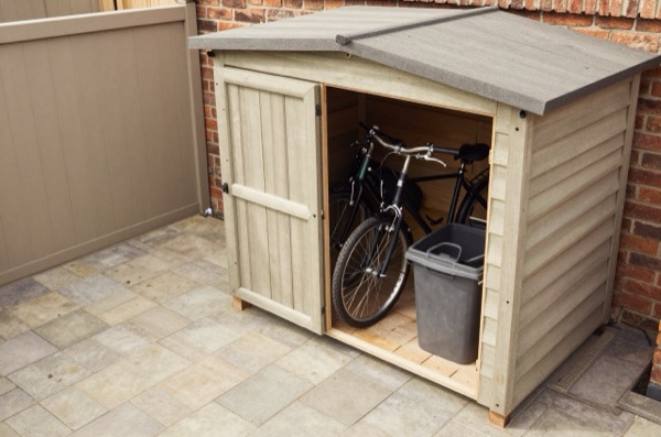 Overhead view of open timber shed storing bikes and bins.