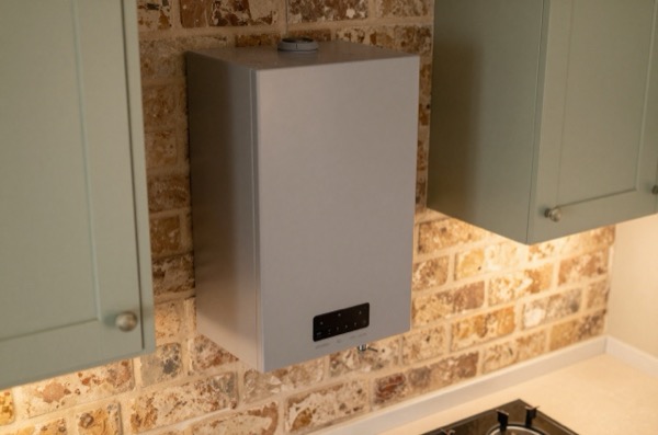 Combi boiler in a renovated British kitchen setting.