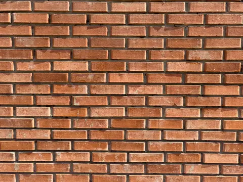 High-resolution image of a red brick wall texture with detailed rustic patterns.