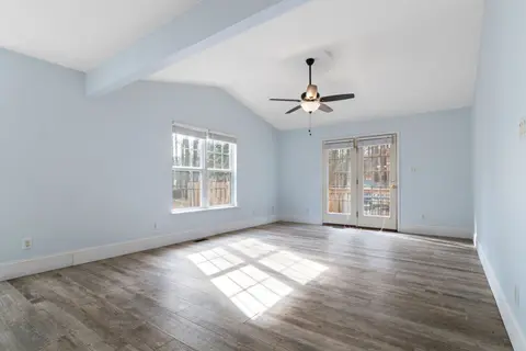 Modern empty room with blue walls and ceiling fan, ideal for interior design inspiration.
