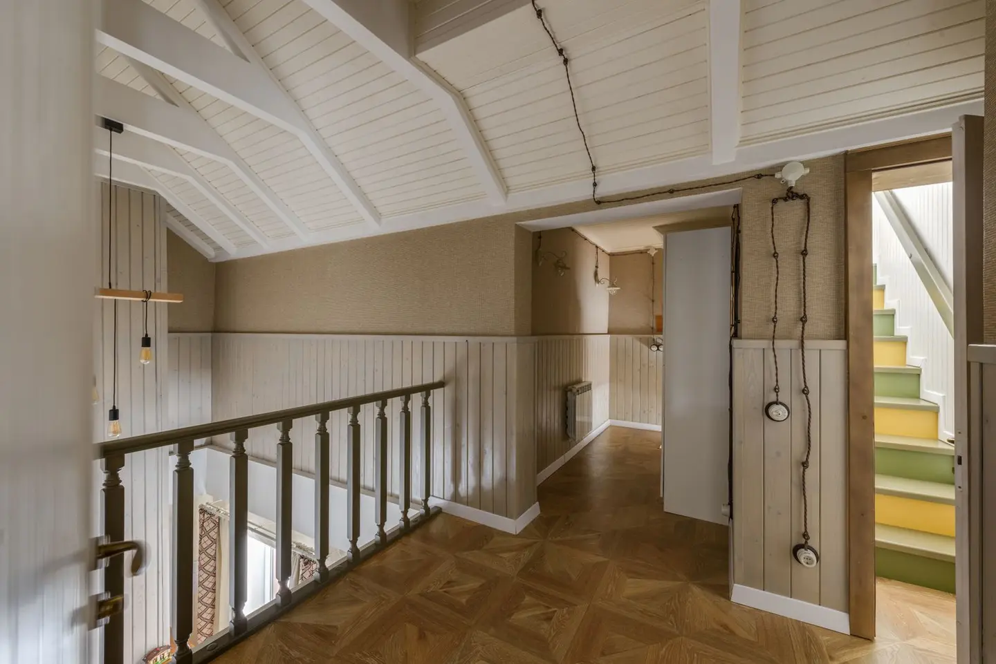 Cozy hallway with wooden interior and a staircase leading to upper floor.