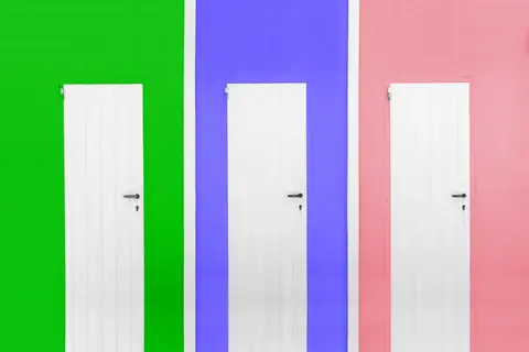 Three white doors against bright green, blue, and pink walls depicting modern style.