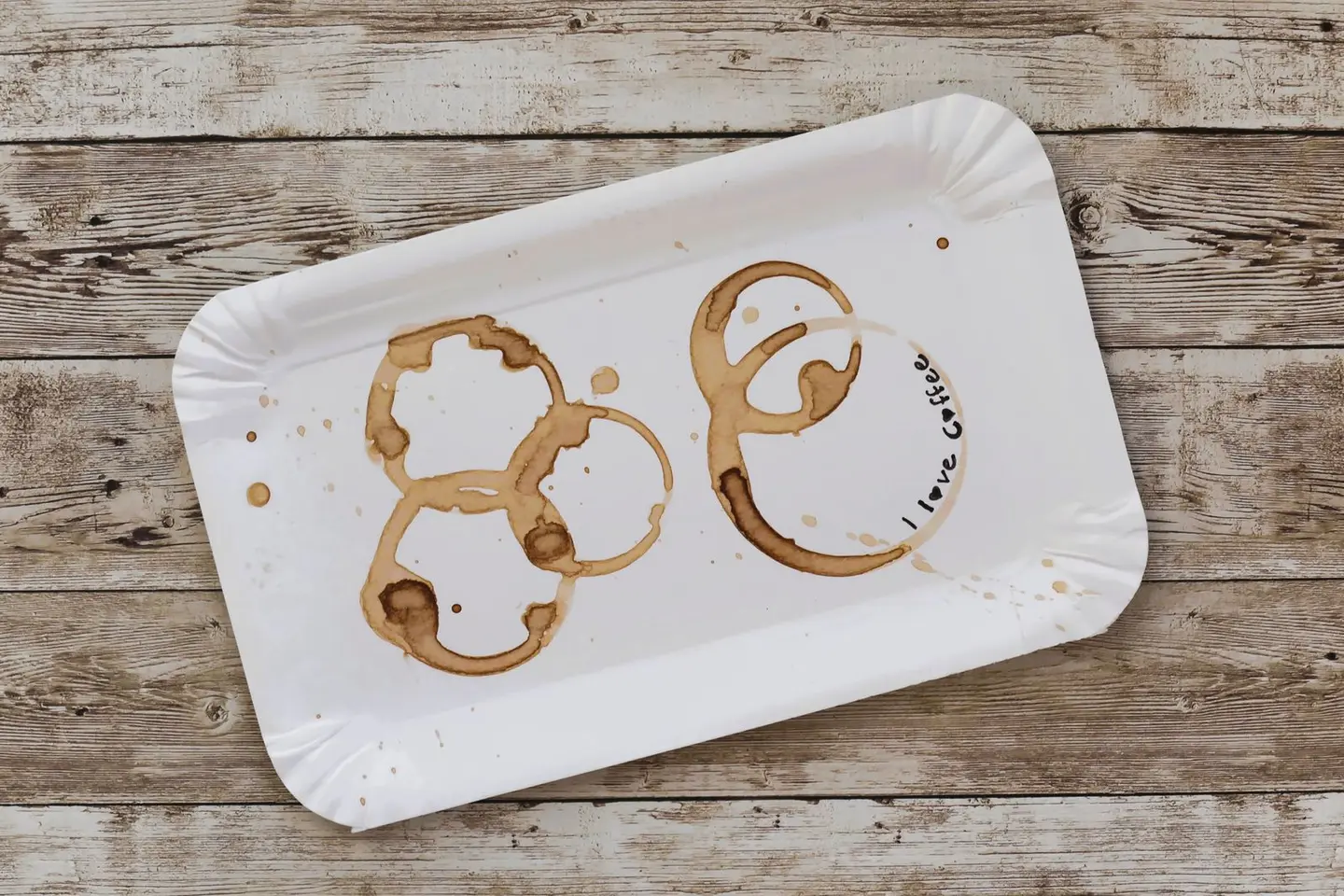 A rustic white tray with artistic coffee stains and 'I love coffee' text.