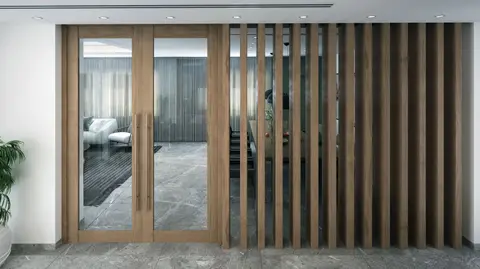 Stylish indoor space featuring a modern glass door with wooden frame and decorative slats.