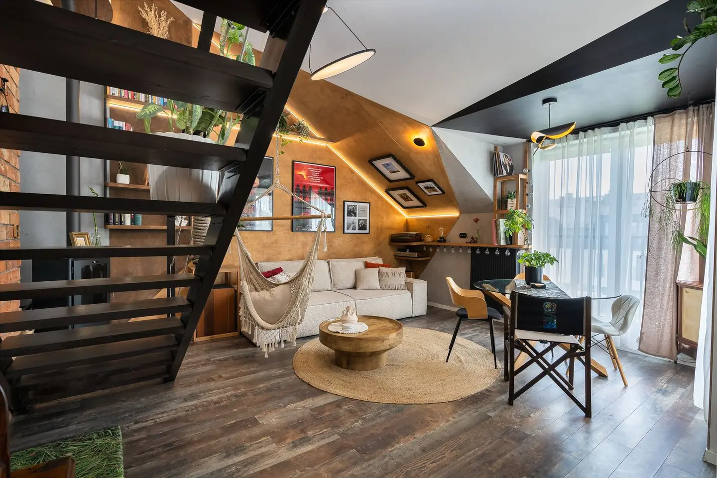 Stylish loft living room featuring a hammock, loft staircase, and modern decor with natural light.