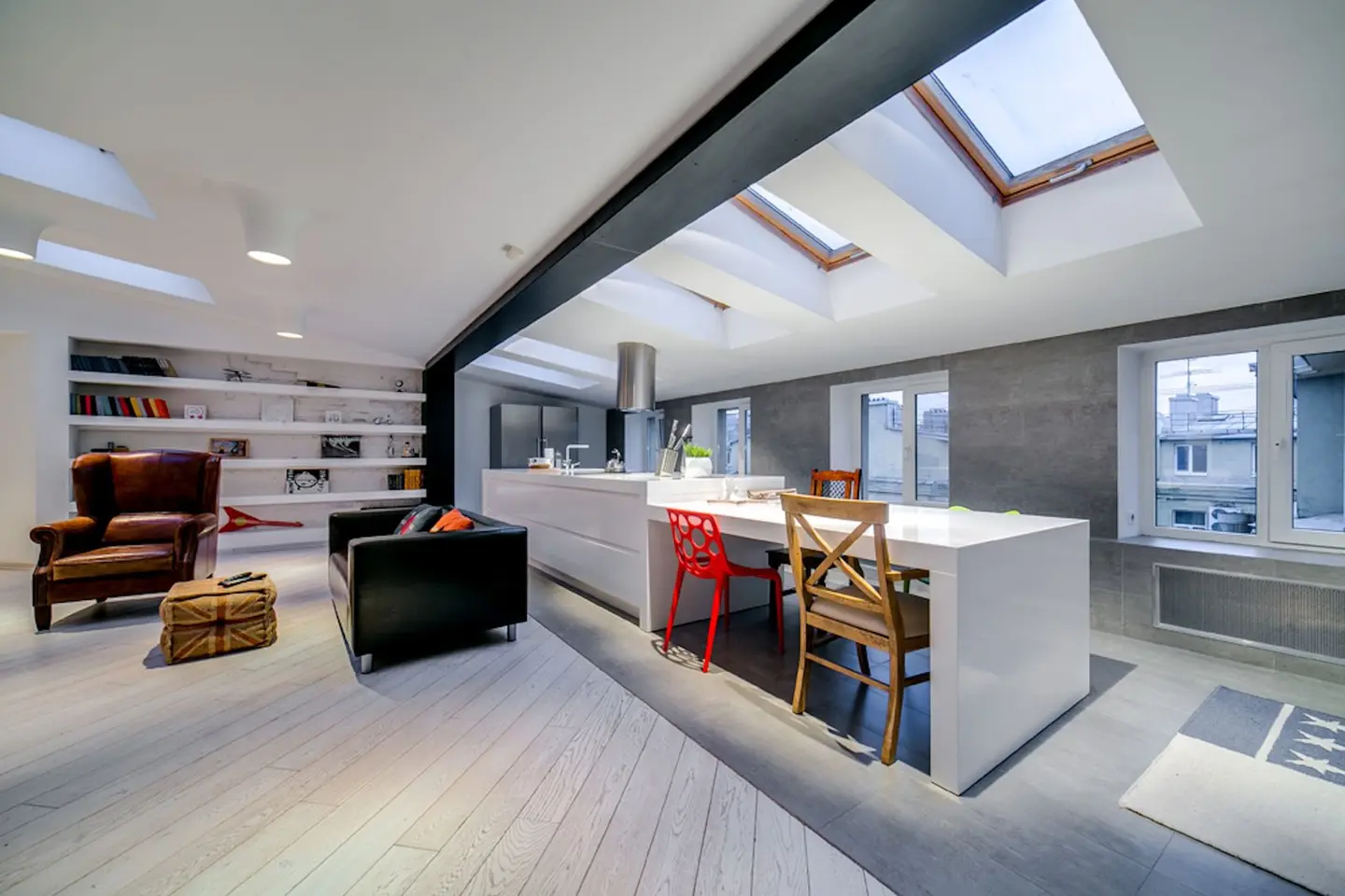 Bright and spacious modern loft with skylights and stylish furnishings.