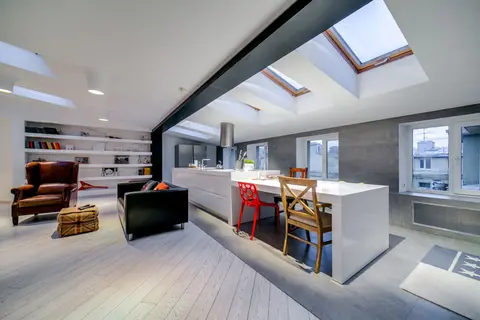 Bright and spacious modern loft with skylights and stylish furnishings.