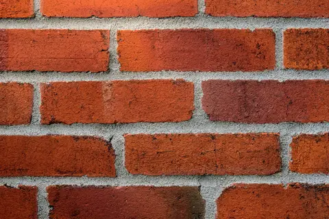 Detailed close-up of a red brick wall showing texture and mortar lines.