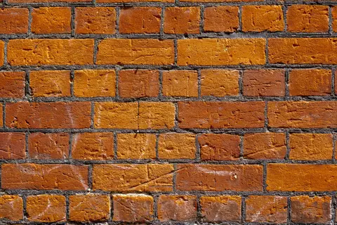 Detailed image of an aged brick wall showcasing rustic texture and colour.